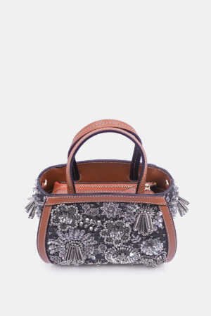 Silver embellished clutch with curved silhouette and removable strap by Versuhz