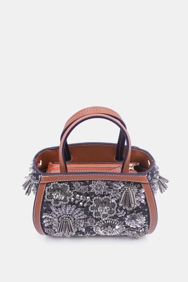 Silver embellished clutch with curved silhouette and removable strap by Versuhz