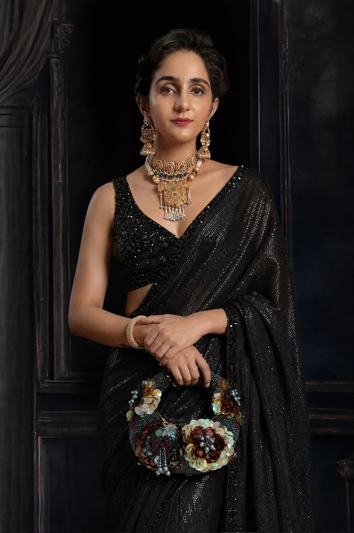 Midnight Gild Luxe Mini Midnight Gild Luxe Mini handcrafted evening bag featuring a structured silhouette adorned with layered floral sequins in antique gold, bronze, gunmetal, black, and iridescent silver tones, embellished with bead clusters on a dark textured base.