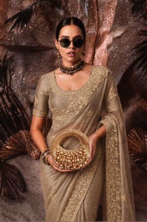 The Golden Grapes Mini Embellished Bag in matte gold with handcrafted grape-inspired bead embroidery, sculptural circular silhouette, and beaded top handle.